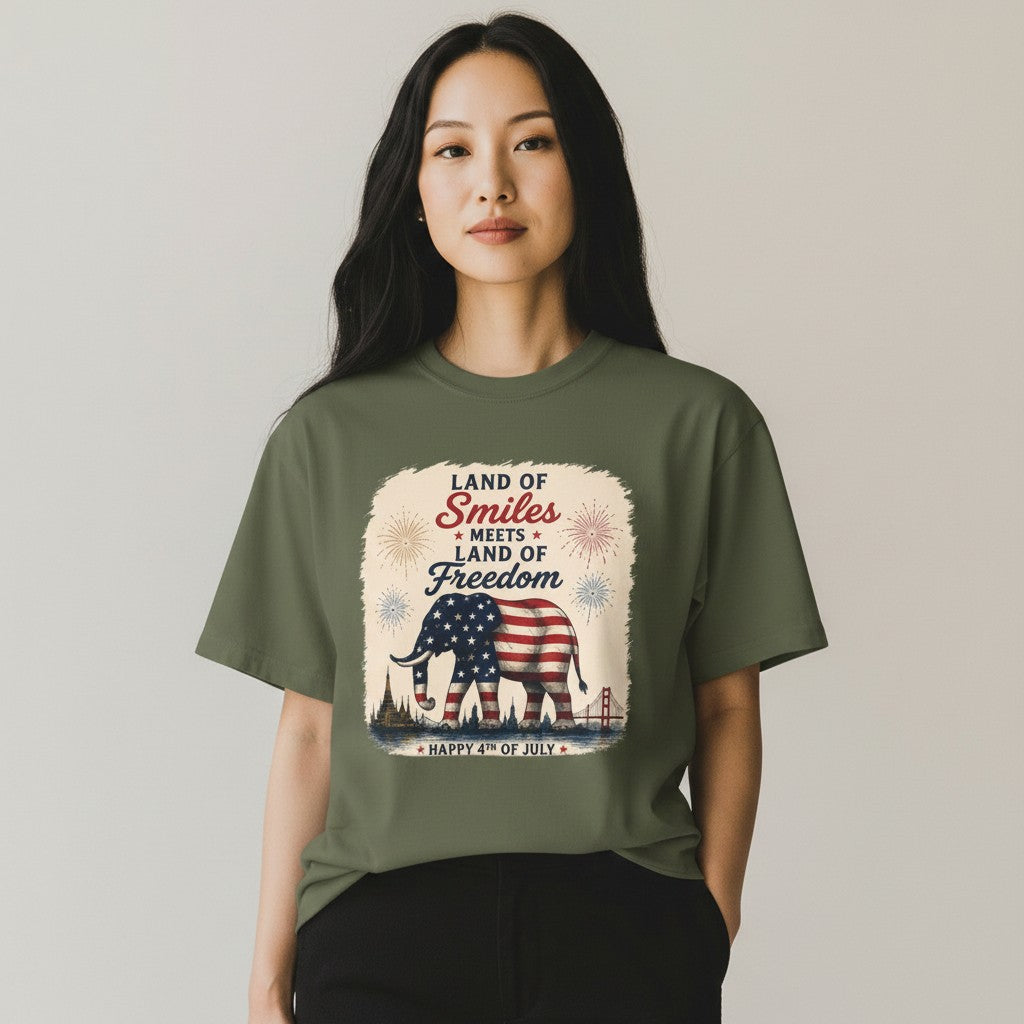 THAILISH.SHOP olive green 100% cotton unisex tee with an elephant draped in the US flag, fireworks, and city skyline.